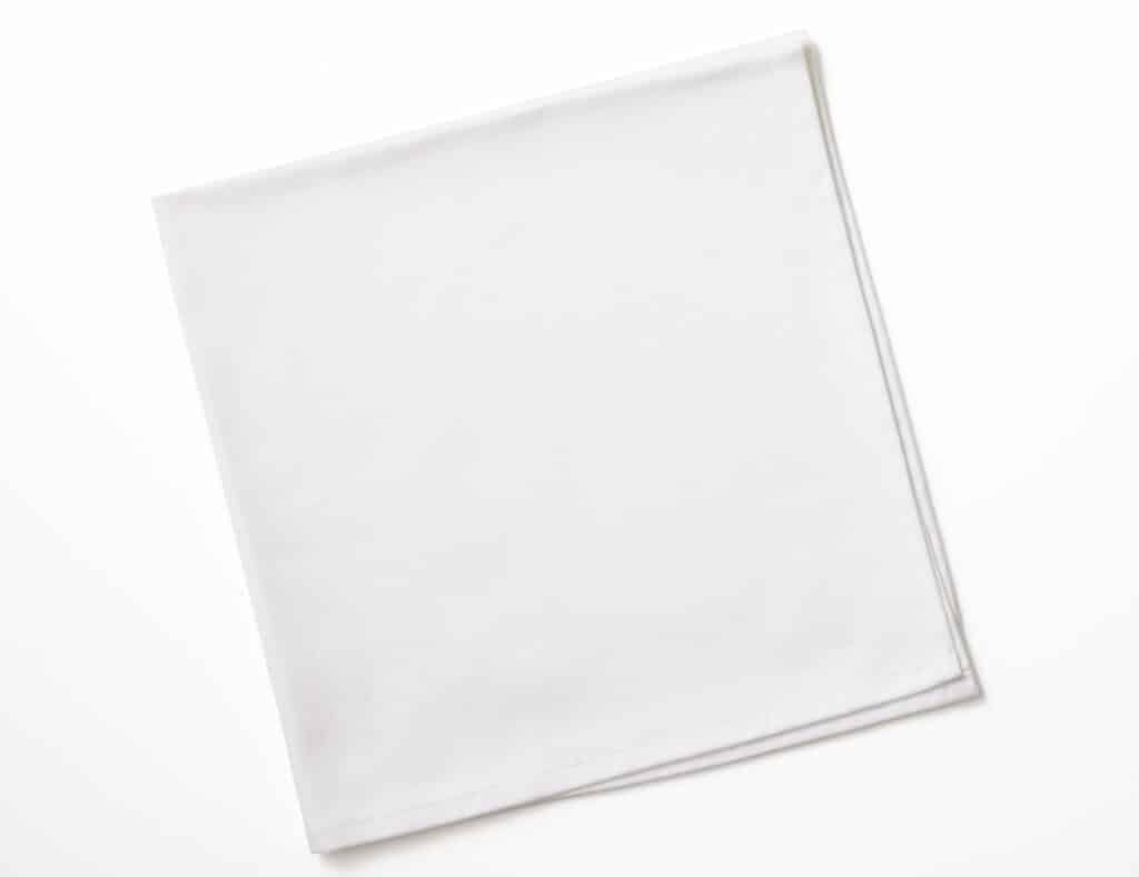 Folded white napkin isolated on white background with clipping path.